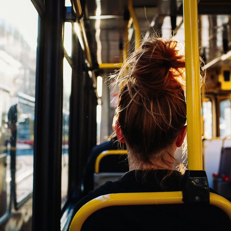 Female sitting in the bus captured from behind
